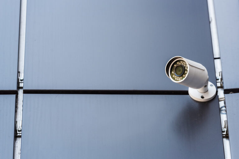security camera on wall of office building, security system concept